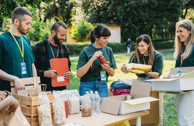 Group of people preparing travel kits for a charity event.