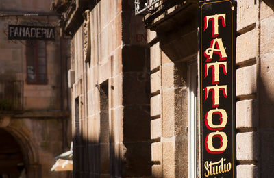Tattoo studio sign on a stone building